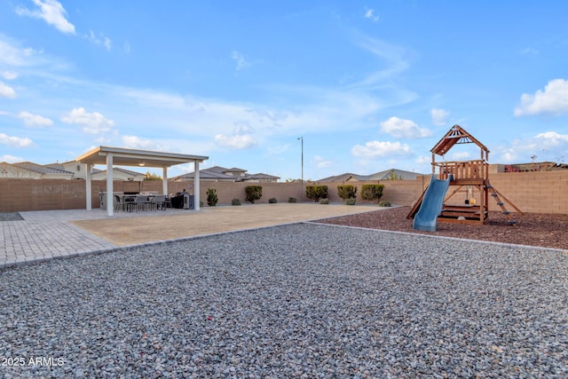 view of playground featuring a patio