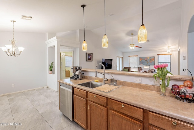 kitchen with lofted ceiling, sink, decorative light fixtures, stainless steel dishwasher, and ceiling fan with notable chandelier