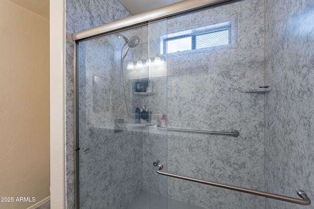 bathroom featuring a shower with shower door