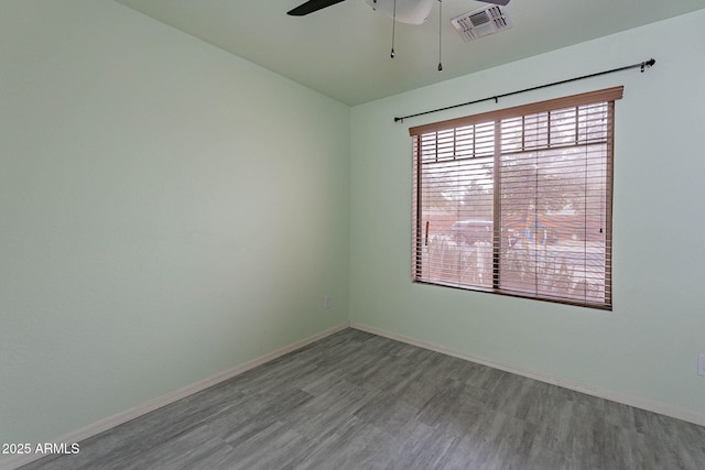 spare room featuring hardwood / wood-style flooring and ceiling fan