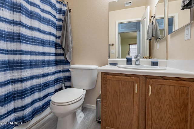 bathroom with vanity, a shower with curtain, and toilet