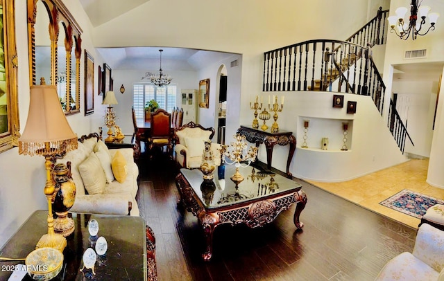 1853 N Rowen Cir, Mesa, AZ 85207 - living area featuring a chandelier, stairs, wood finished floors, high vaulted ceiling, and arched walkways