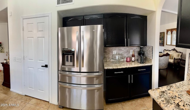1853 N Rowen Cir, Mesa, AZ 85207 - kitchen featuring stainless steel fridge, light tile patterned flooring, dark cabinetry, and light stone counters