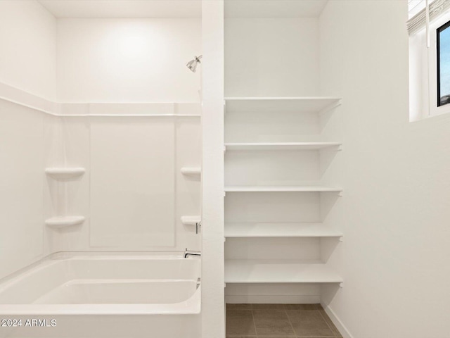 bathroom featuring tile patterned floors and  shower combination