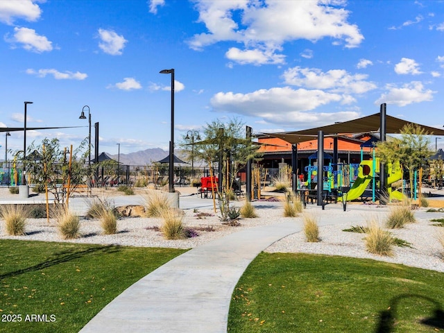 view of home's community featuring a mountain view and a playground