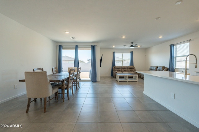 tiled dining room featuring plenty of natural light, sink, and ceiling fan