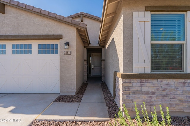 view of exterior entry featuring a garage