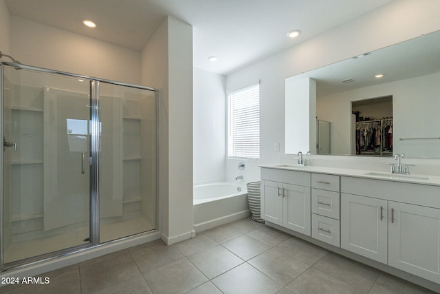 bathroom featuring independent shower and bath, vanity, and tile patterned floors