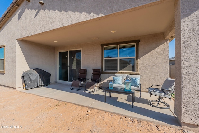 back of property featuring outdoor lounge area and a patio