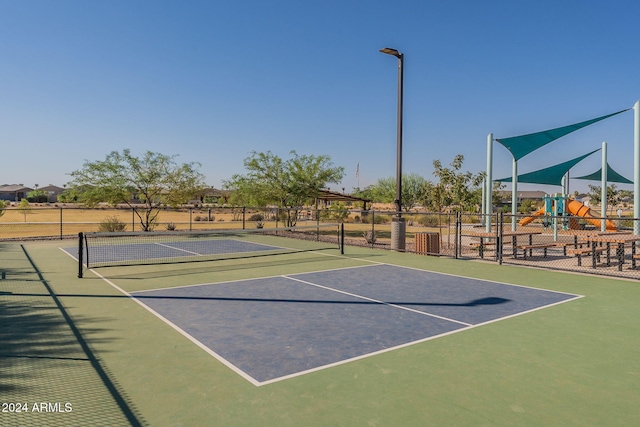 view of sport court with a playground and basketball hoop