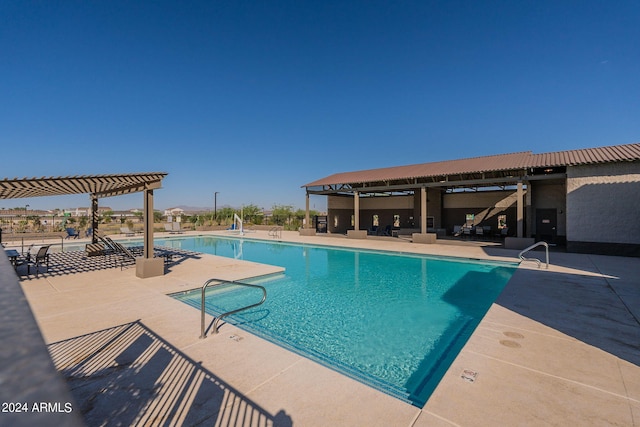 view of swimming pool with a pergola and a patio