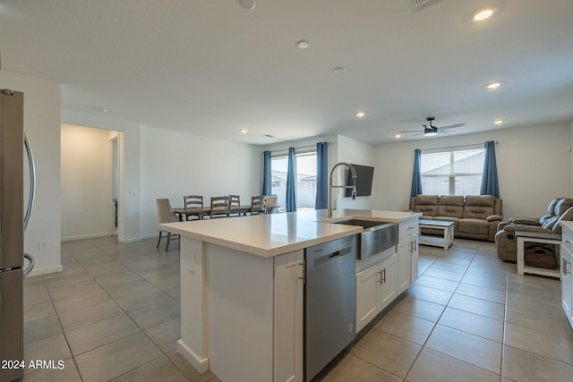 kitchen featuring white cabinets, light tile patterned floors, sink, a center island with sink, and appliances with stainless steel finishes