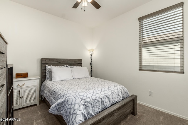 bedroom featuring ceiling fan and dark colored carpet