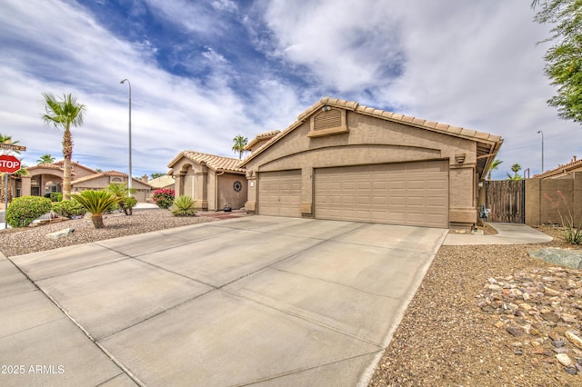 1217 S Longmore Ct, Chandler, AZ 85286 - mediterranean / spanish-style home with concrete driveway, a garage, a tile roof, and stucco siding
