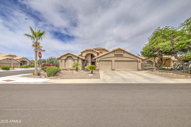 1217 S Longmore Ct, Chandler, AZ 85286 - mediterranean / spanish-style home featuring an attached garage, stucco siding, concrete driveway, and a tile roof