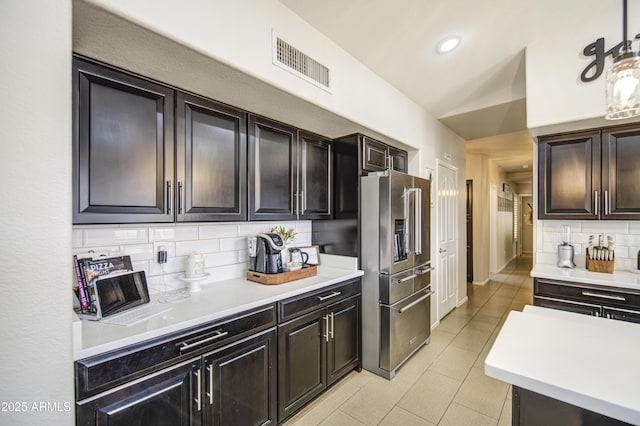 1217 S Longmore Ct, Chandler, AZ 85286 - kitchen featuring high end refrigerator, tasteful backsplash, light countertops, light tile patterned floors, and vaulted ceiling