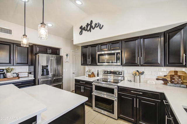 1217 S Longmore Ct, Chandler, AZ 85286 - kitchen with appliances with stainless steel finishes, light countertops, backsplash, vaulted ceiling, and pendant lighting