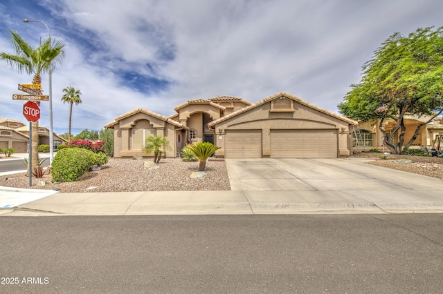1217 S Longmore Ct, Chandler, AZ 85286 - mediterranean / spanish-style house featuring a garage, concrete driveway, stucco siding, and a tile roof