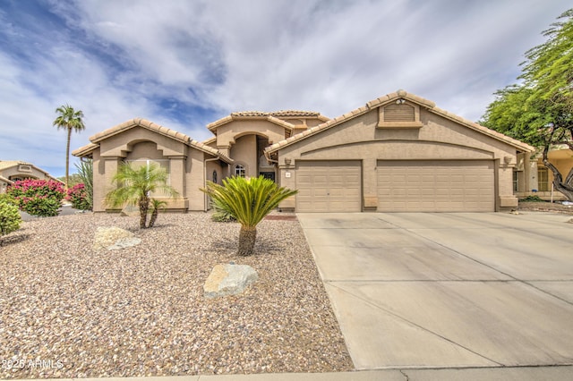 1217 S Longmore Ct, Chandler, AZ 85286 - mediterranean / spanish house with driveway, stucco siding, an attached garage, and a tiled roof