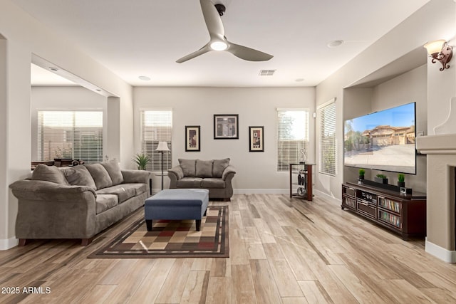 living room with ceiling fan and light wood-type flooring