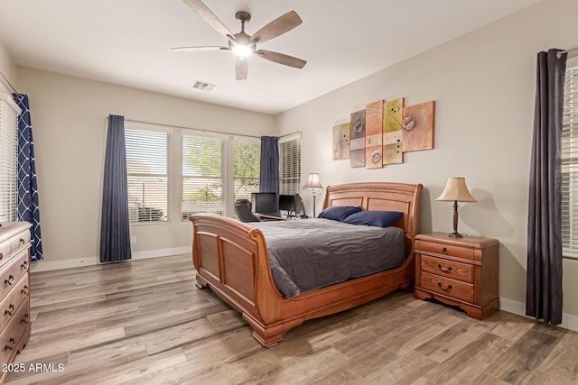 bedroom with light hardwood / wood-style flooring and ceiling fan