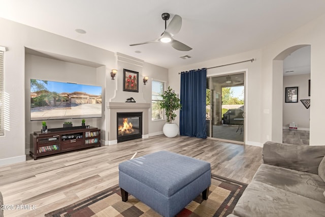 living room with hardwood / wood-style floors and ceiling fan