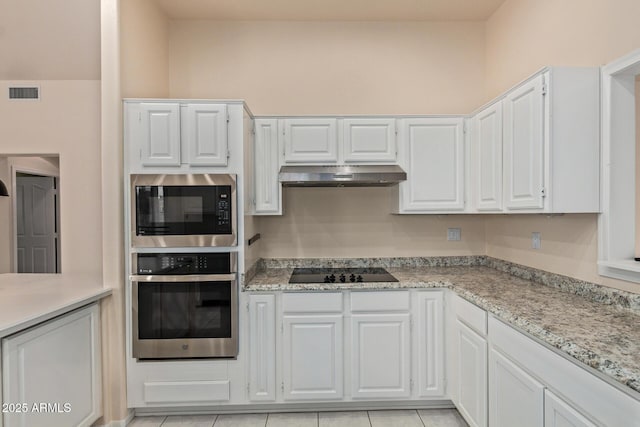 kitchen featuring visible vents, black electric cooktop, under cabinet range hood, stainless steel oven, and built in microwave