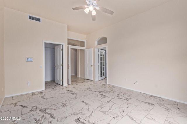 unfurnished bedroom with visible vents, marble finish floor, a ceiling fan, and baseboards