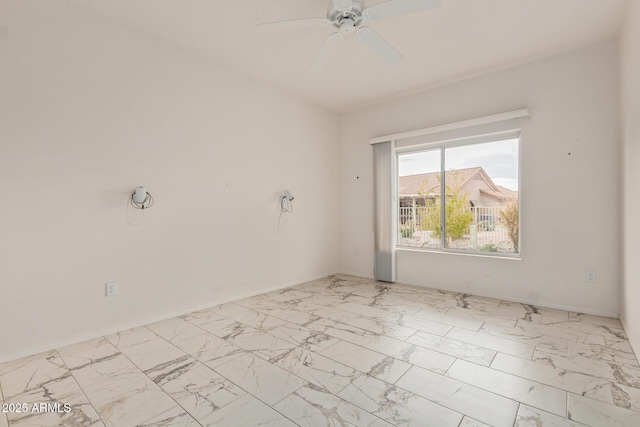 empty room with marble finish floor and a ceiling fan