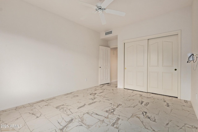 unfurnished bedroom featuring visible vents, a ceiling fan, marble finish floor, and a closet