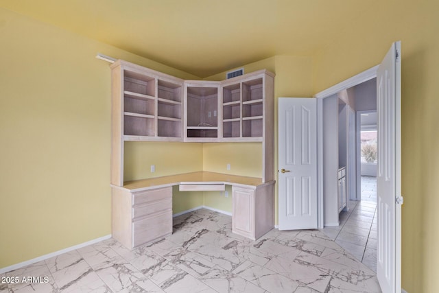 unfurnished office featuring baseboards, visible vents, marble finish floor, and built in study area