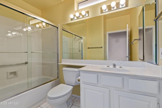 bathroom with tile patterned flooring, toilet, vanity, and bath / shower combo with glass door