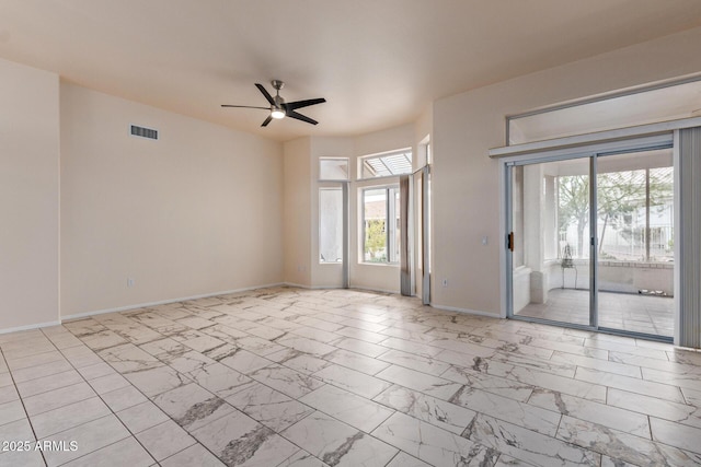 unfurnished room with visible vents, baseboards, marble finish floor, and ceiling fan