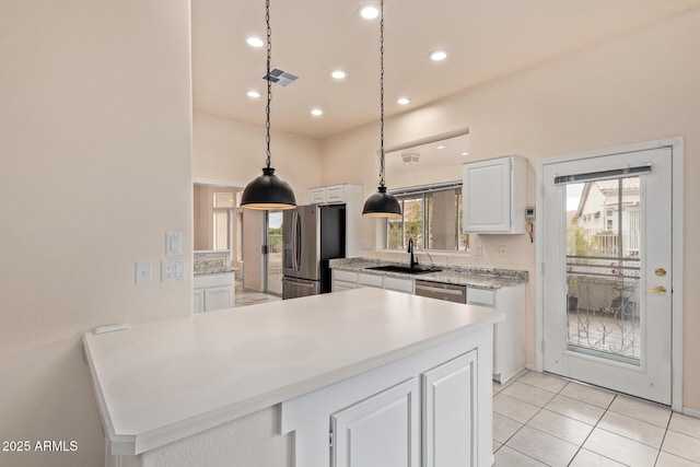 kitchen featuring visible vents, a sink, white cabinetry, appliances with stainless steel finishes, and light countertops