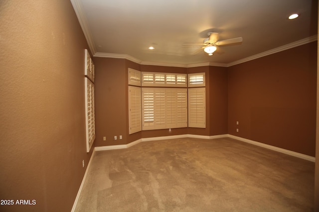 carpeted empty room featuring a ceiling fan, recessed lighting, crown molding, and baseboards