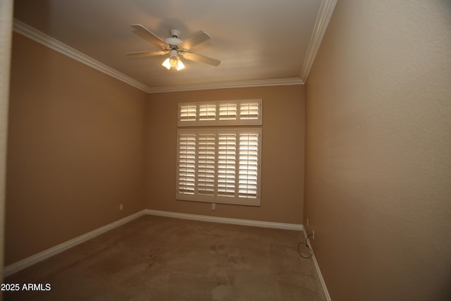 carpeted empty room featuring baseboards, ornamental molding, and a ceiling fan