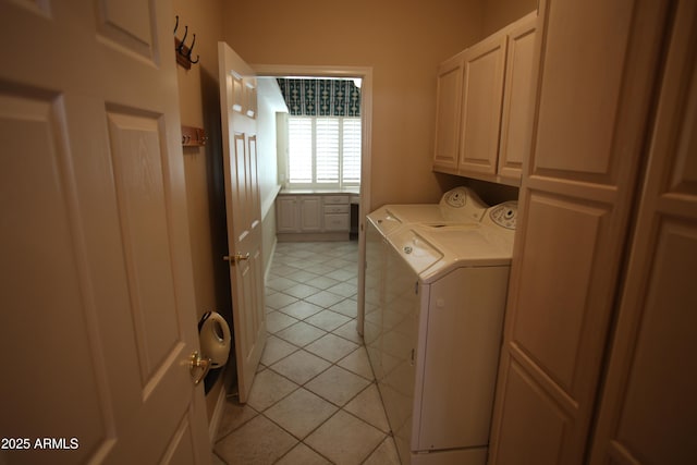 clothes washing area featuring cabinet space, light tile patterned floors, and separate washer and dryer