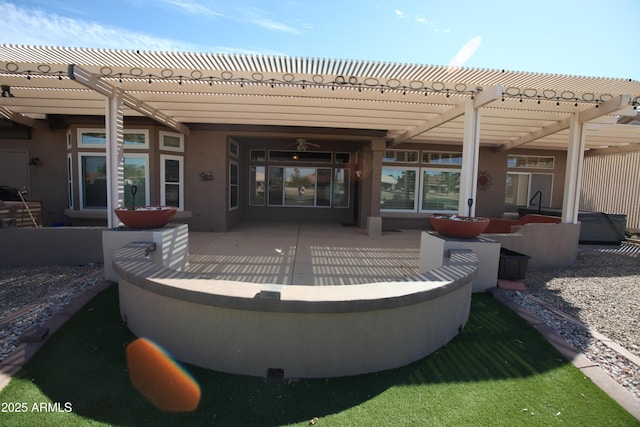 back of house with a patio area, stucco siding, and a pergola