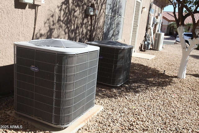 details featuring stucco siding and central air condition unit