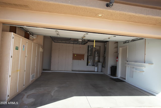 garage with secured water heater and visible vents