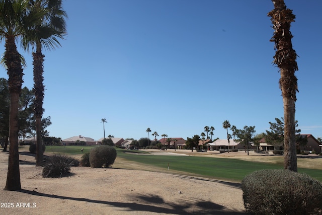 surrounding community featuring view of golf course and a lawn