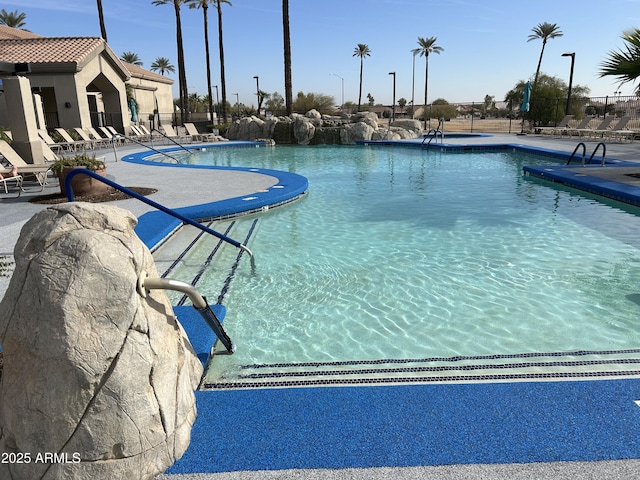 pool featuring a patio area and fence