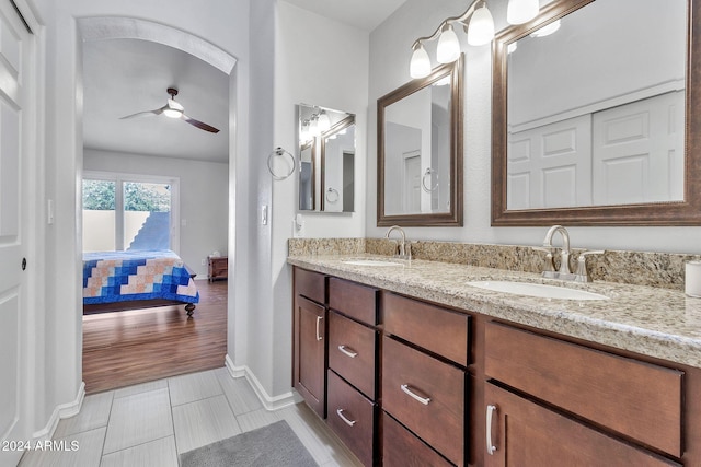 bathroom with ceiling fan, vanity, and hardwood / wood-style flooring