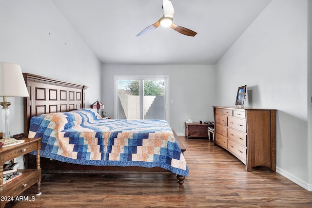 bedroom featuring dark hardwood / wood-style floors, ceiling fan, access to outside, and vaulted ceiling