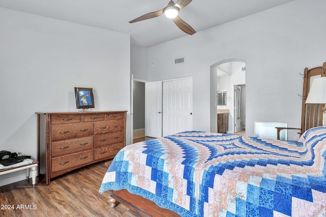 bedroom featuring ceiling fan, wood-type flooring, and ensuite bath