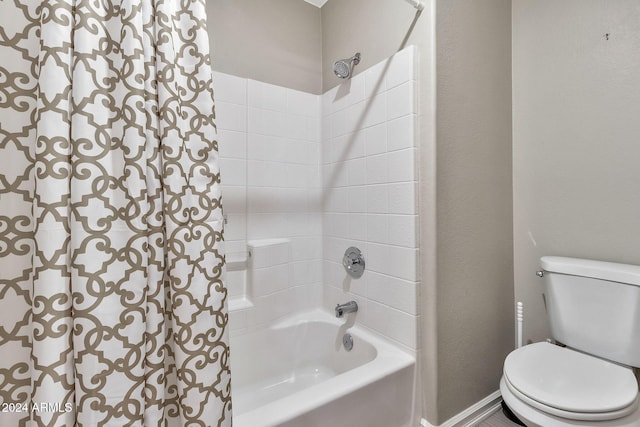 bathroom featuring shower / tub combination and toilet