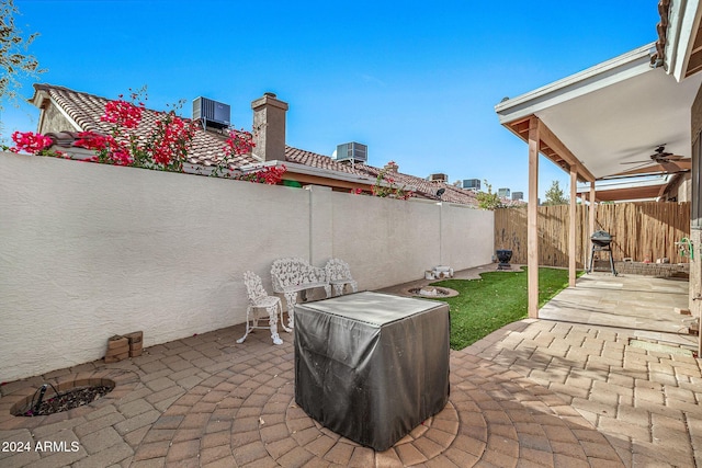 view of patio / terrace featuring central air condition unit, area for grilling, and ceiling fan