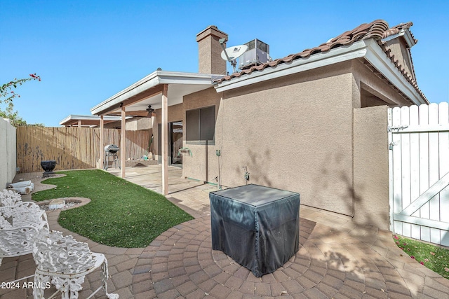 back of house with a patio area, ceiling fan, and cooling unit