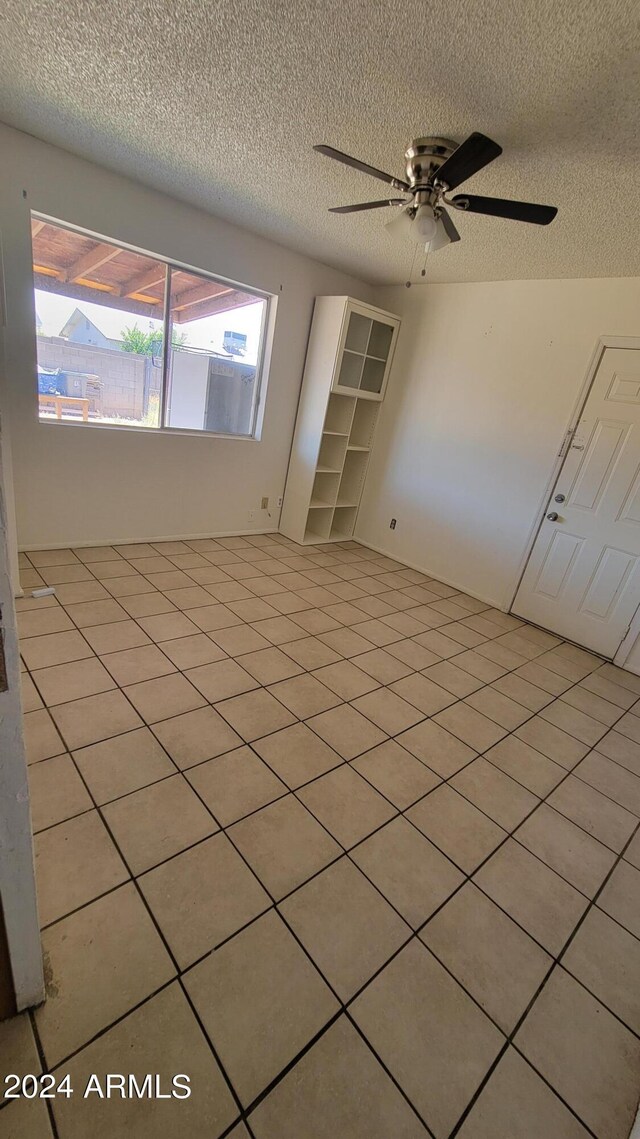 bathroom featuring tiled shower, tile patterned floors, toilet, and vanity