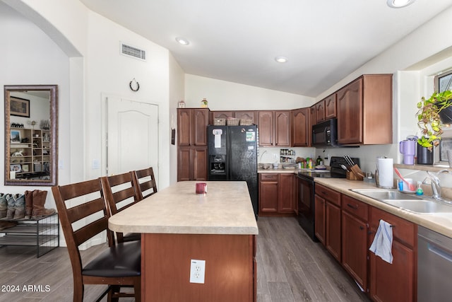 kitchen featuring sink, dark hardwood / wood-style flooring, lofted ceiling, a kitchen island, and black appliances